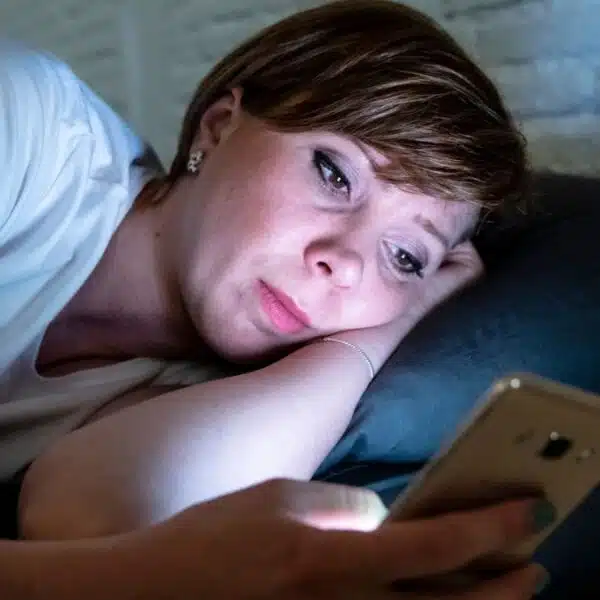 woman on phone social media night