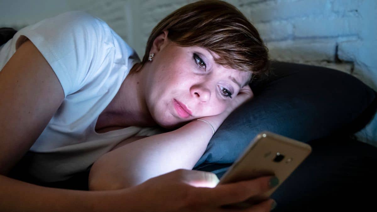 woman on phone social media night
