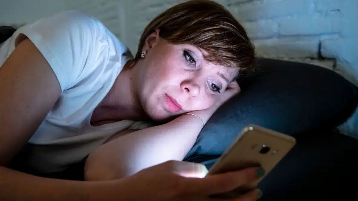 woman on phone social media night