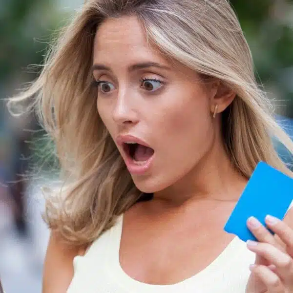 woman shocked holdling phone and credit card