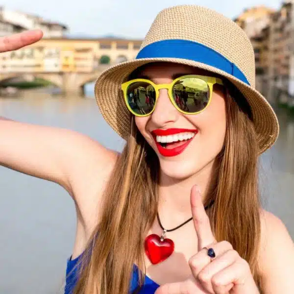 woman smiling with hat outside on travel