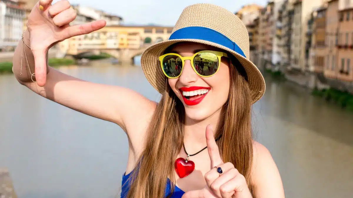woman smiling with hat outside on travel