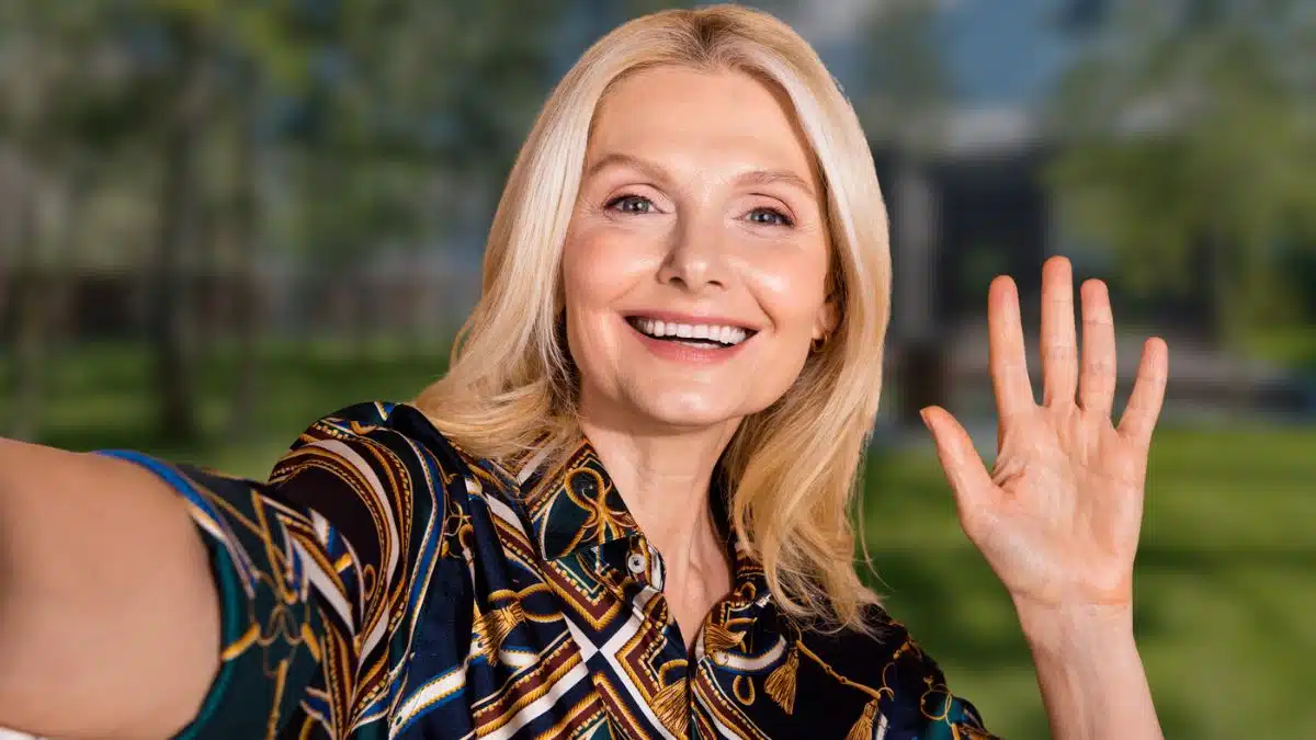 woman waving smiling elder mature