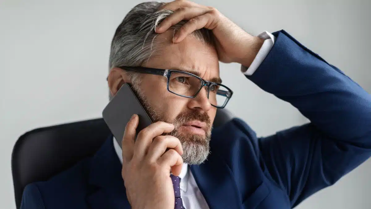 businessman beard glasses calling on the phone