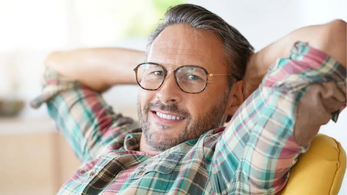 mature man glasses beard relaxing home