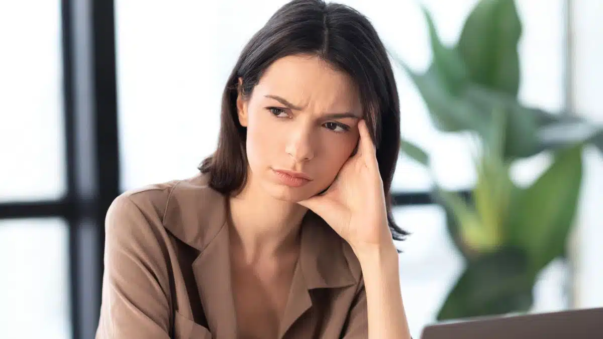 woman sitting in a office thinking