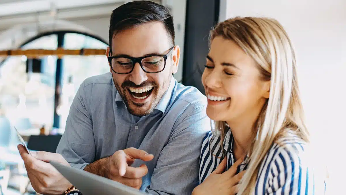 friends laughing with tablet