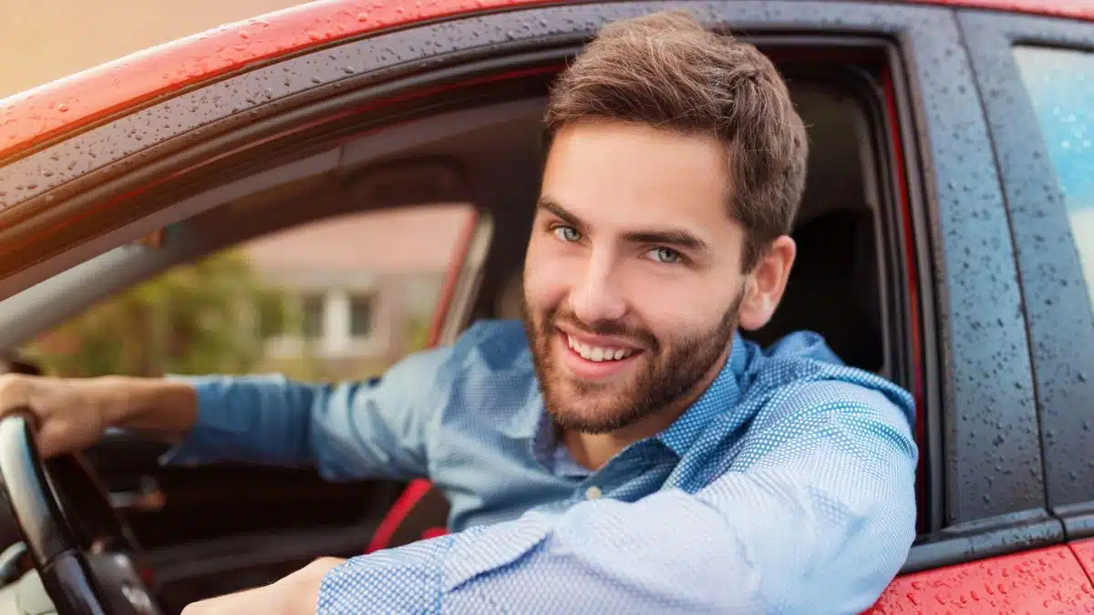 man leaning outside of car