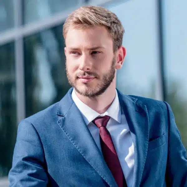 man suit standing outside staring