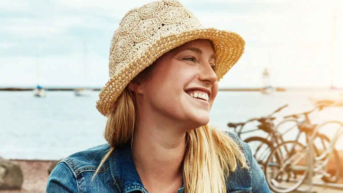 woman biking hat outside smile