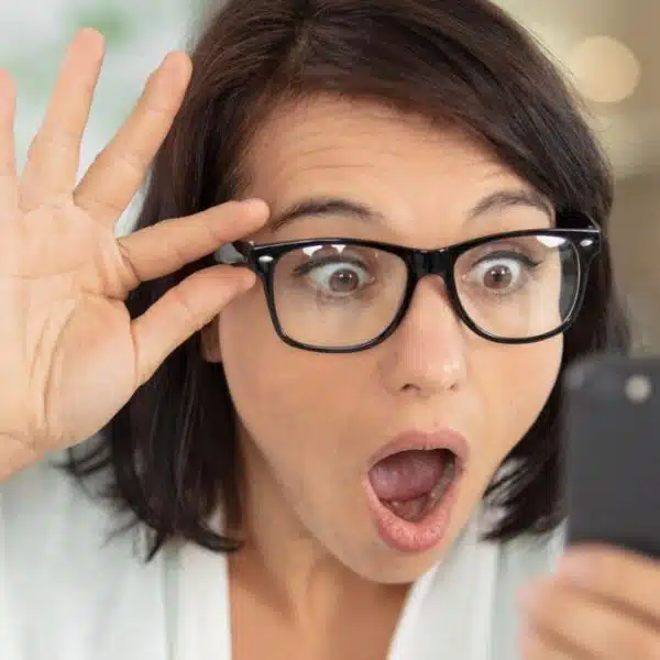 woman glasses amazed phone