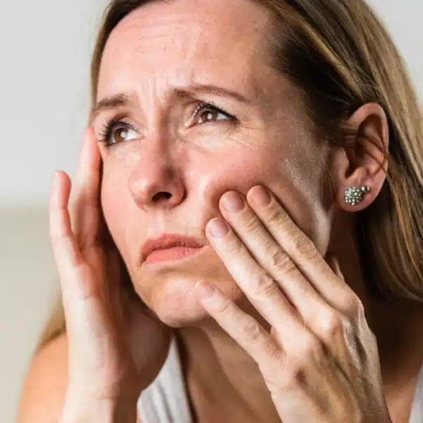 woman looking out her window sad