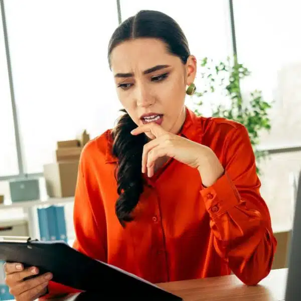 woman red shirt working at a desk