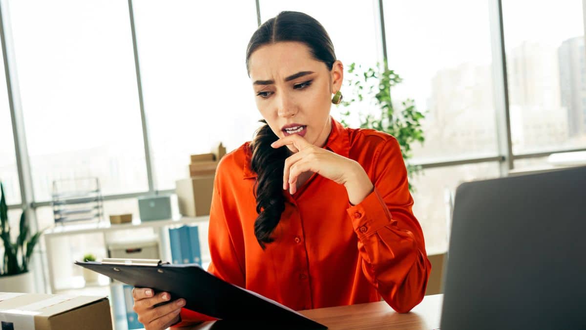 woman red shirt working at a desk