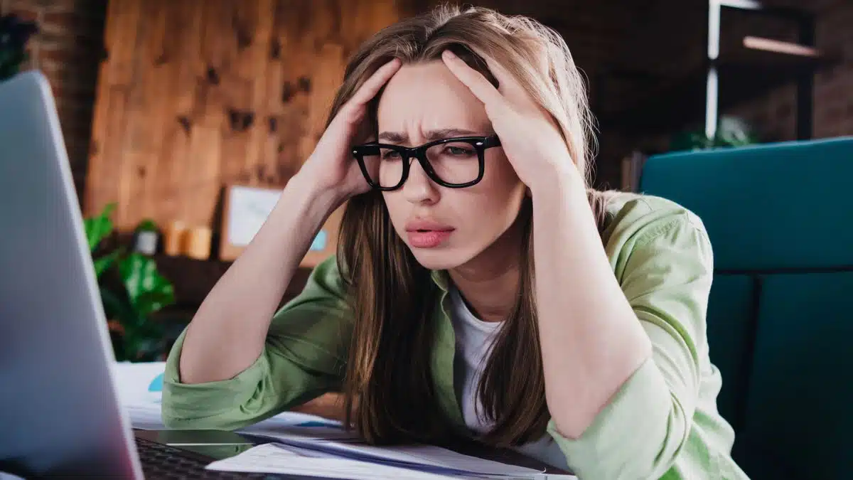 woman stressed at her desk not happy