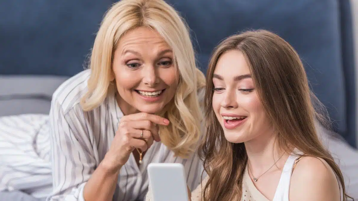 women family laughing tablet
