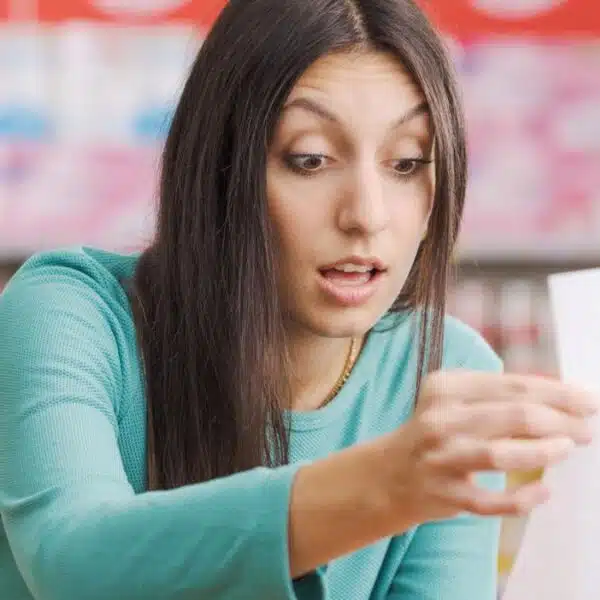 Woman reviewing her grocery bill