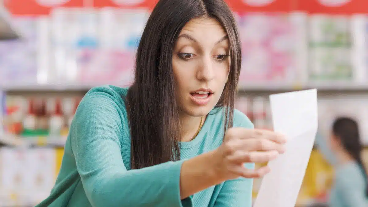 Woman reviewing her grocery bill
