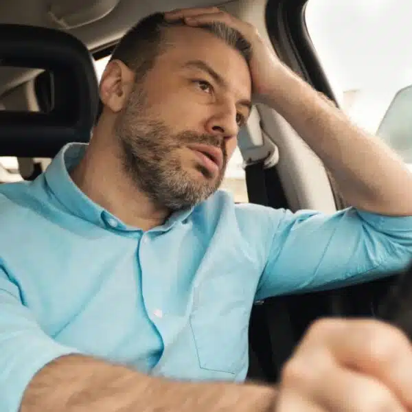 man driving a car