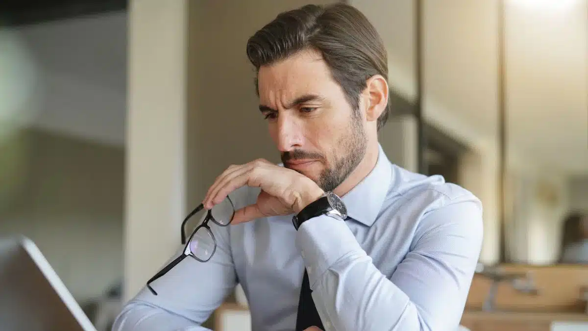 man tie looking at computer