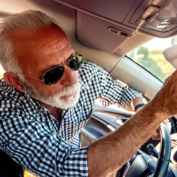 man with sunglasses cleaning his car