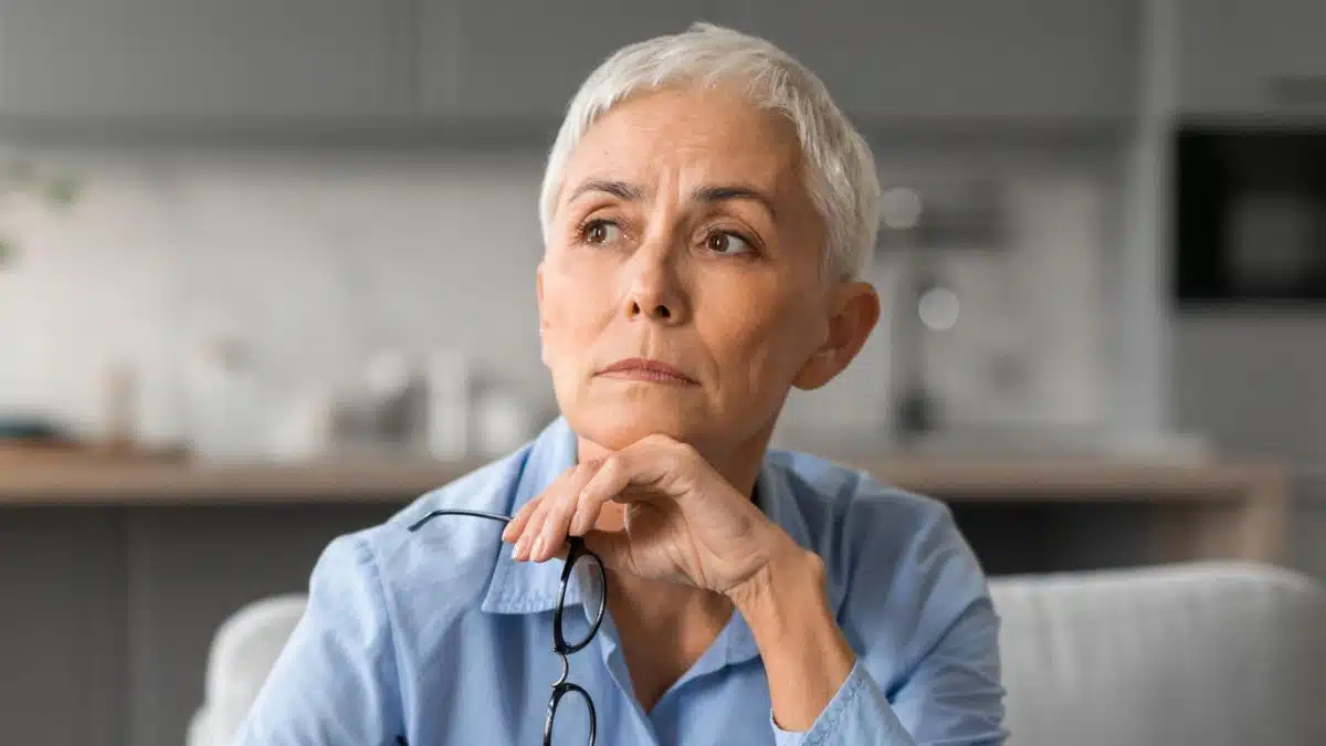 mature woman glasses thinking to herself