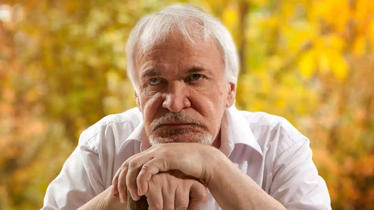 senior man leaning on a cane