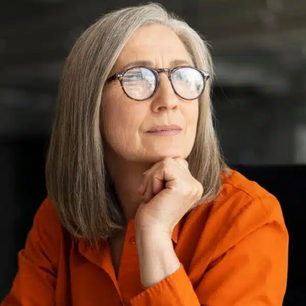 senior woman glasses in office thinking