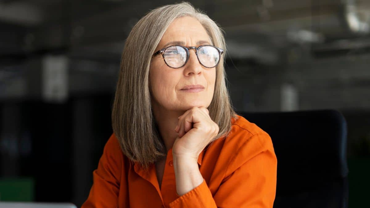 senior woman glasses in office thinking