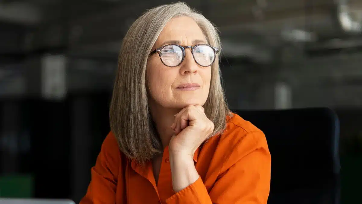 senior woman glasses in office thinking