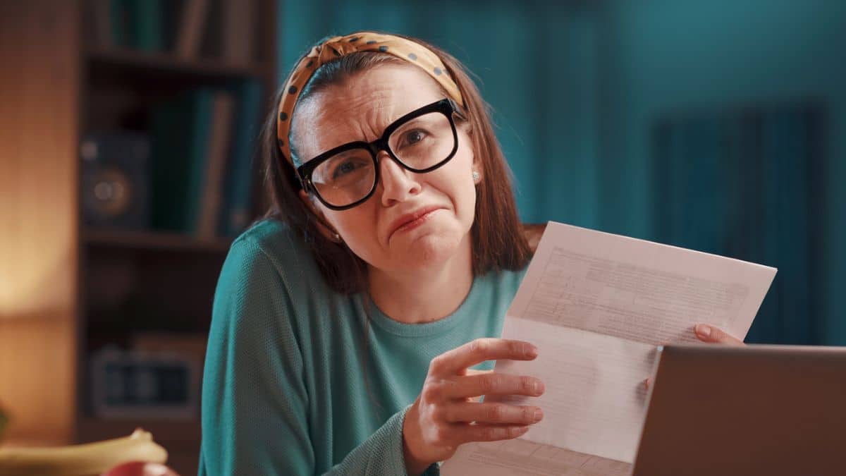 woman glasses bills stress no money
