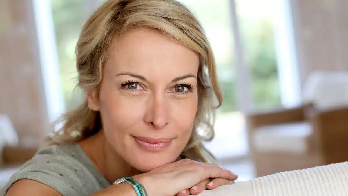 woman on couch smiling