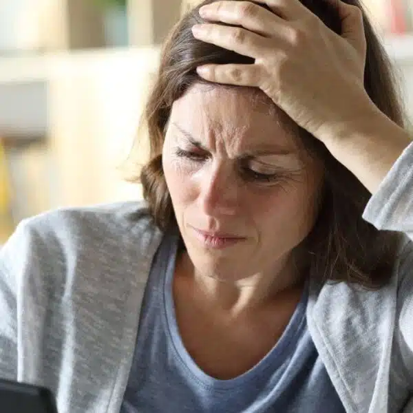 woman sad reading her phone