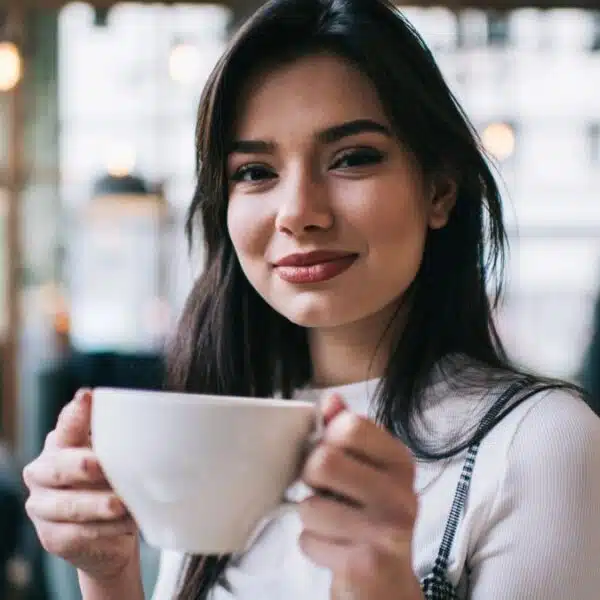 Woman drinking coffee at a cafe