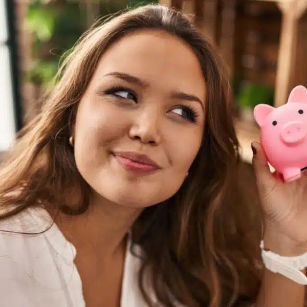 Woman holding a small piggy bank