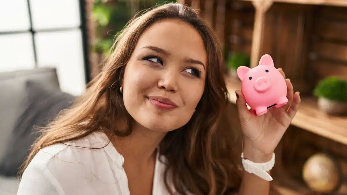 Woman holding a small piggy bank
