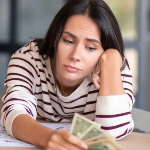 Woman staring at her dollars