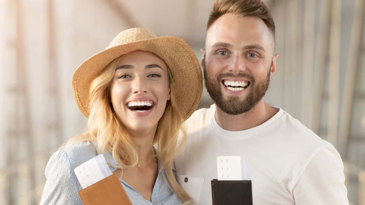 couple holding their tickets and wallets
