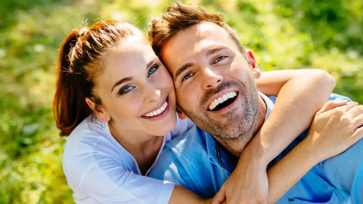 couple smiling in the grass