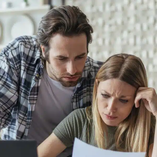 couple staring at their bank statement