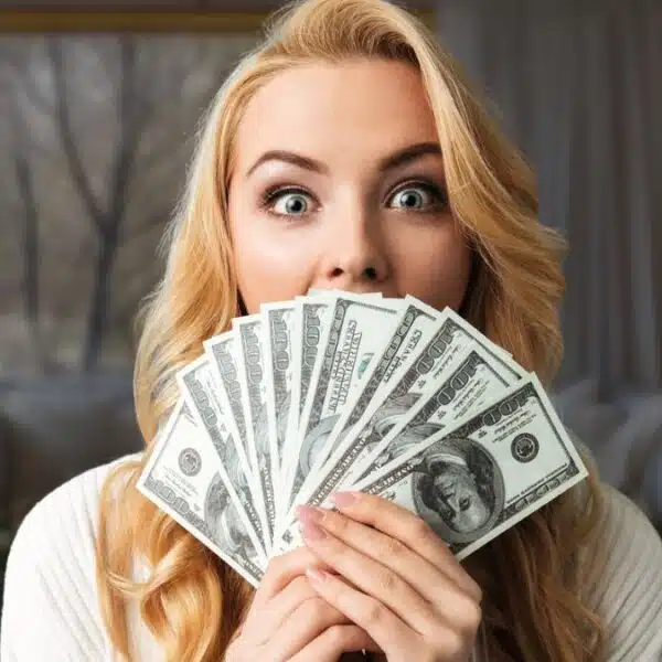 Woman holding cash at home