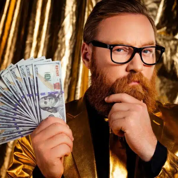 man glasses gold suit holding cash