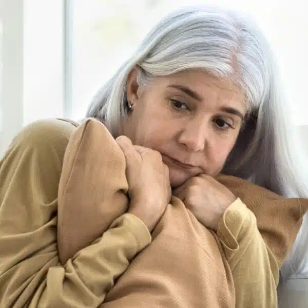 mature woman hugging a pillow