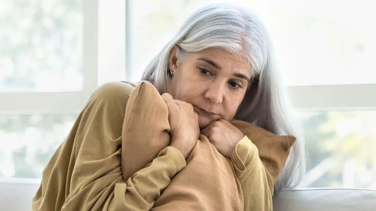 mature woman hugging a pillow