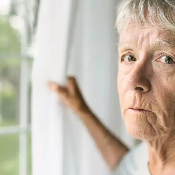 mature woman staring out the window