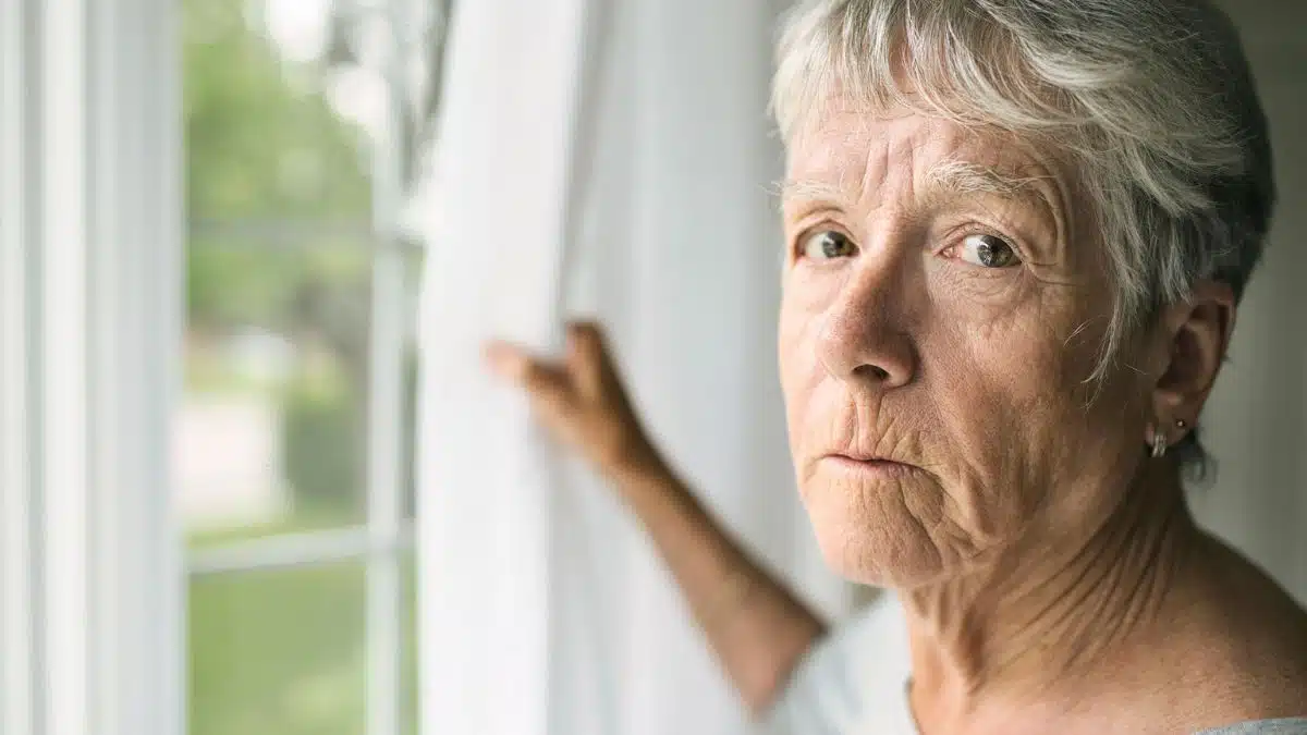 mature woman staring out the window