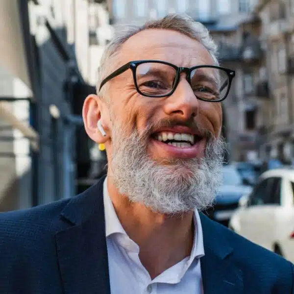 senior man smiling outside glasses