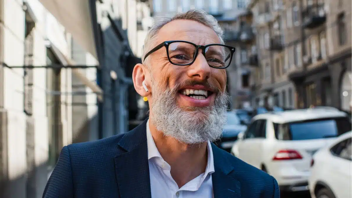 senior man smiling outside glasses