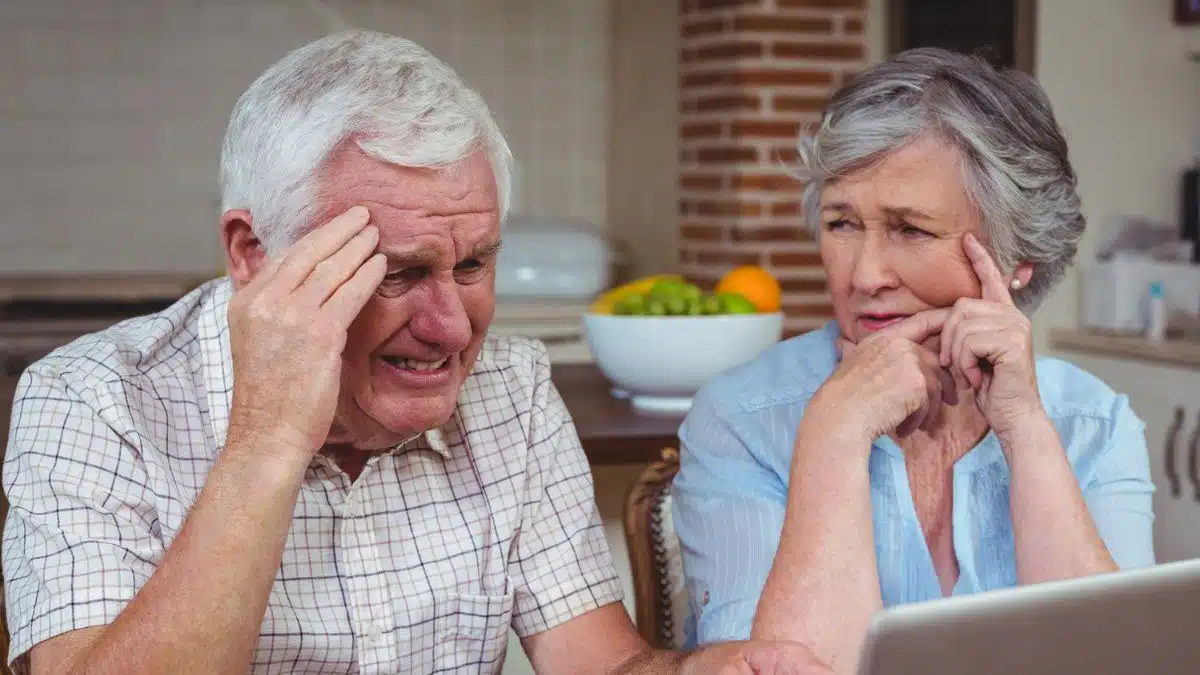 senior man upset looking at the laptop