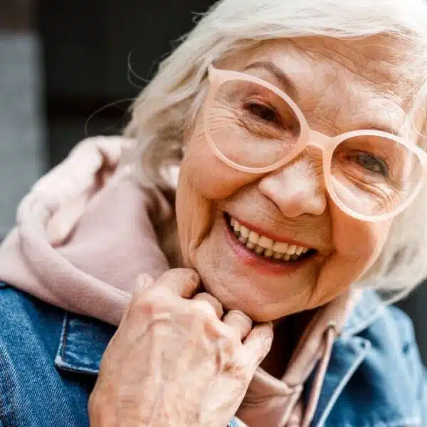 senior woman jean jacket and glasses